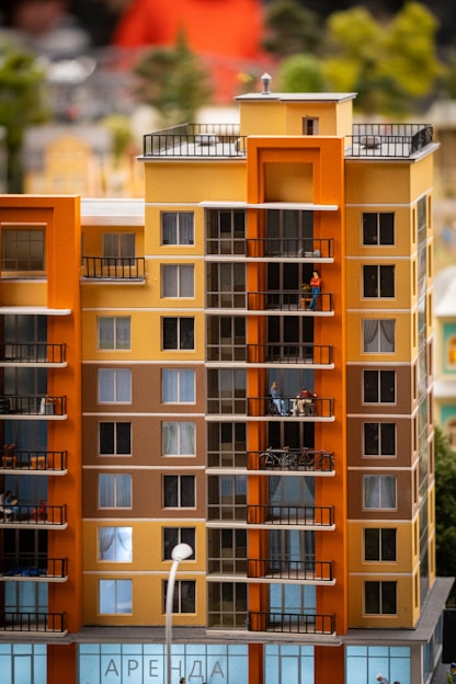 a tall orange building with balconies and balconies