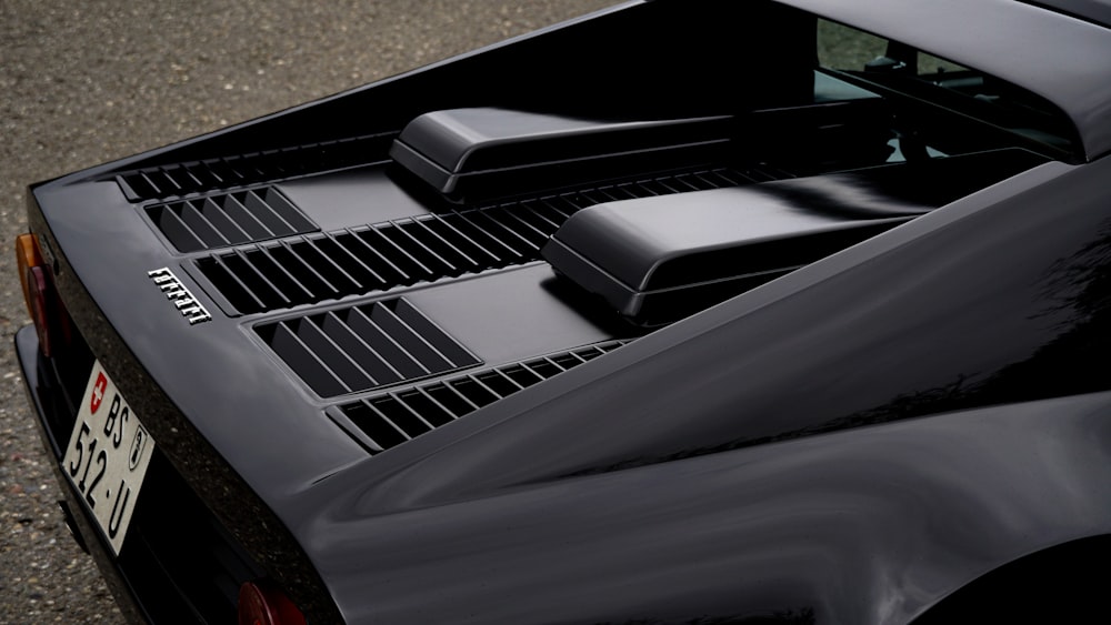 a close up of the hood of a black sports car