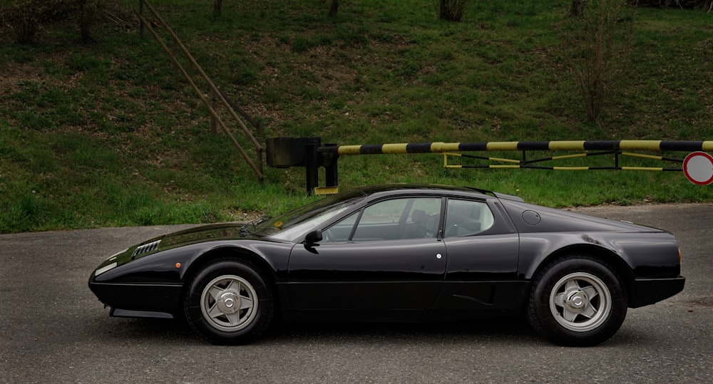 a black sports car parked on the side of the road