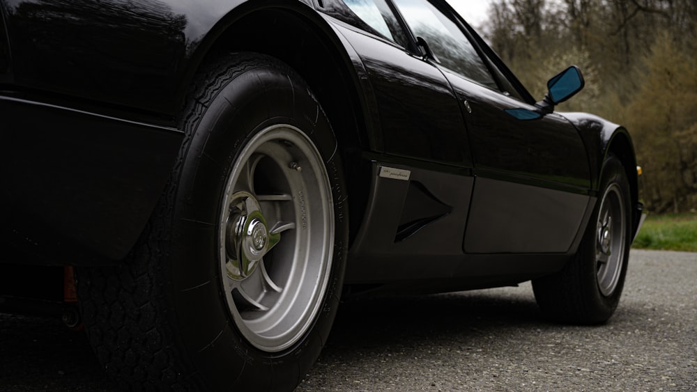 a black sports car parked on the side of the road