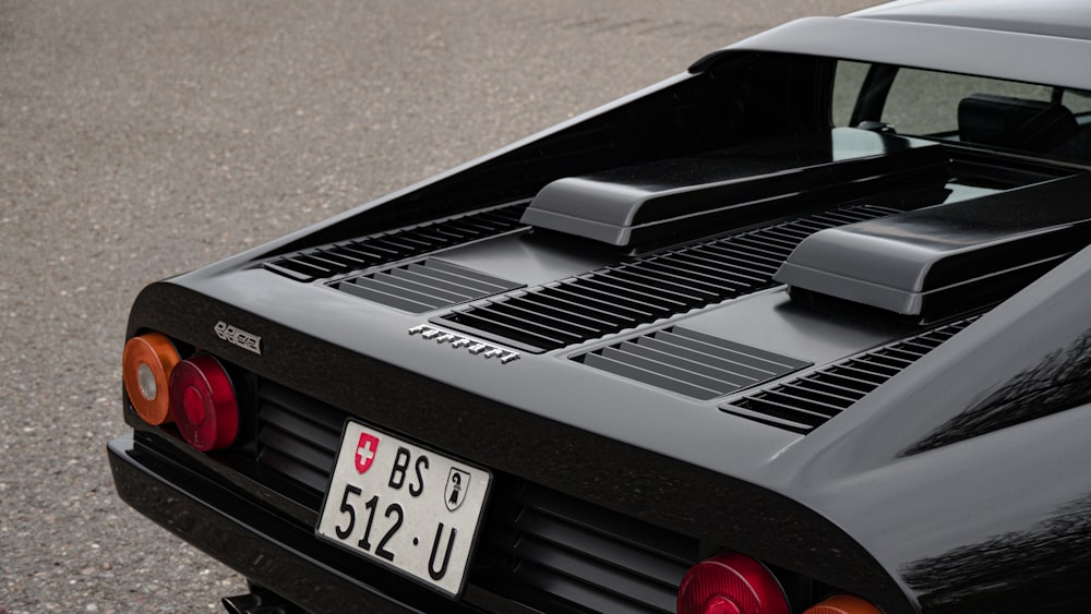 the rear end of a black sports car