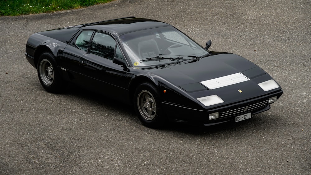 a black sports car parked in a parking lot