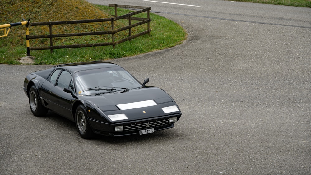 a black sports car parked on the side of a road