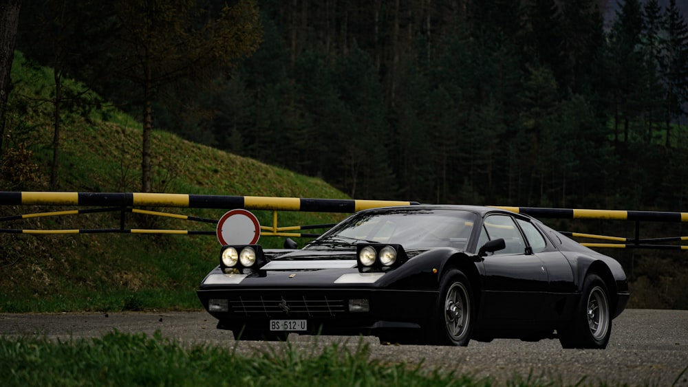 a black sports car parked on the side of a road