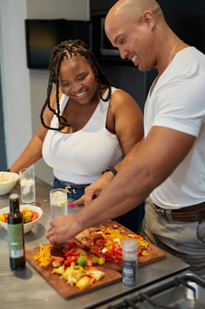 a group of people preparing food in a kitchen