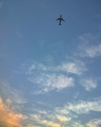 an airplane is flying high in the sky