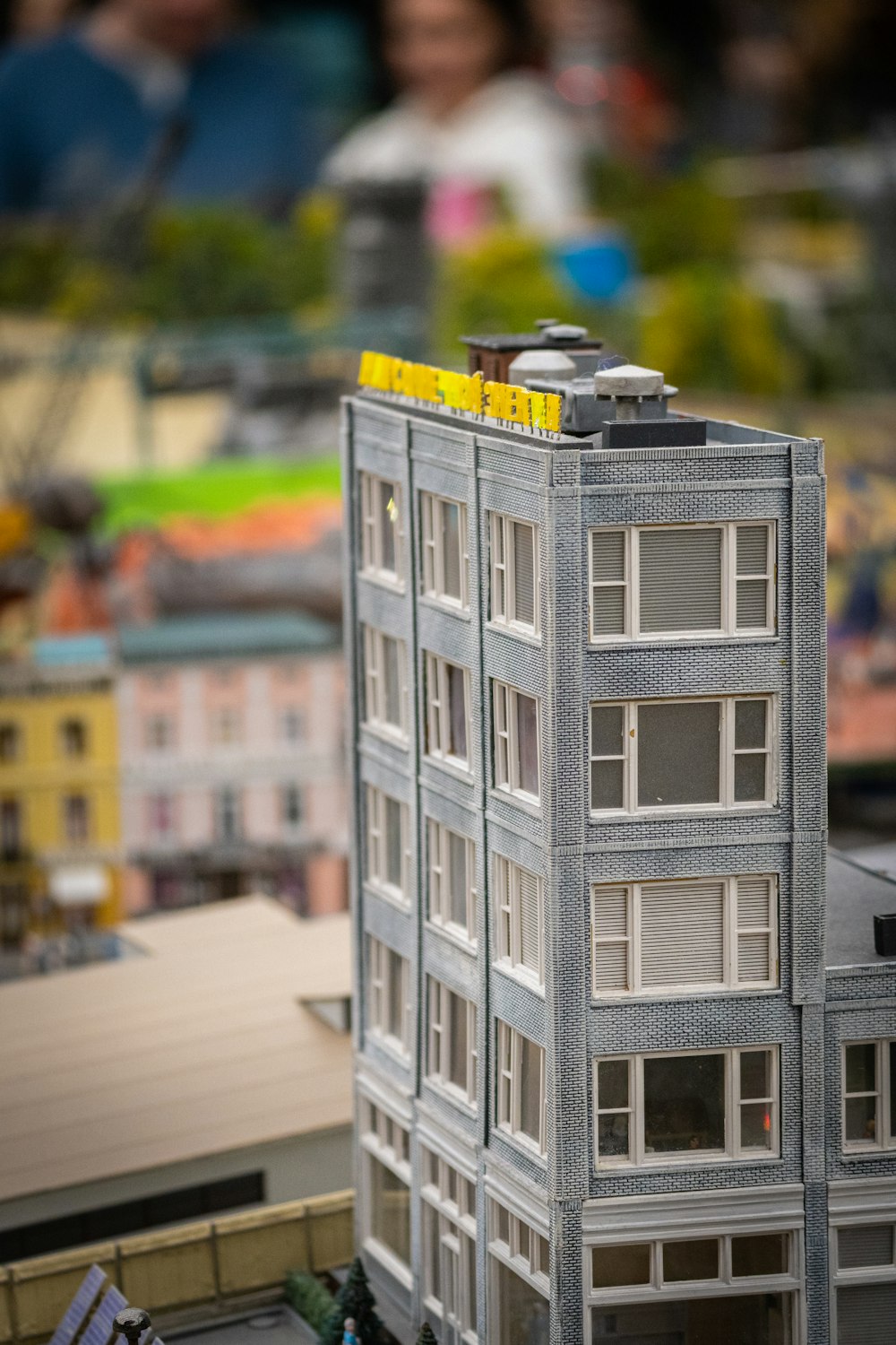 a model of a building with people in the background