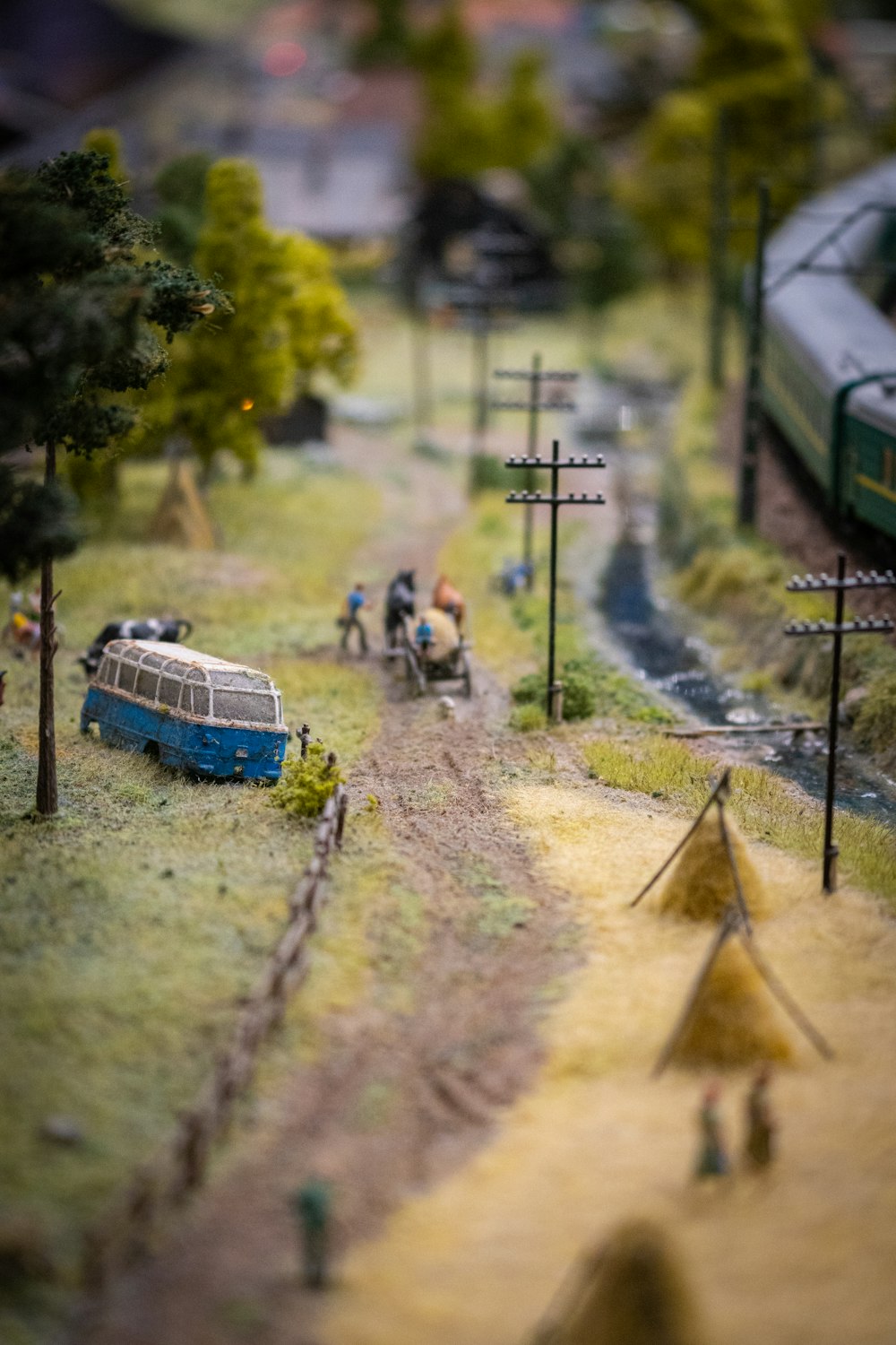 a model of a train station with a bus and people