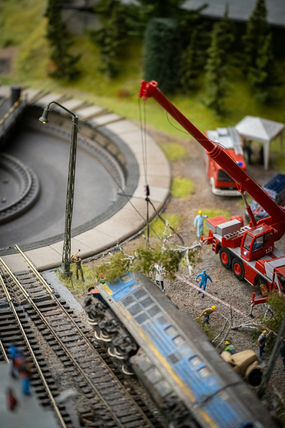 a model train track with a crane on top of it