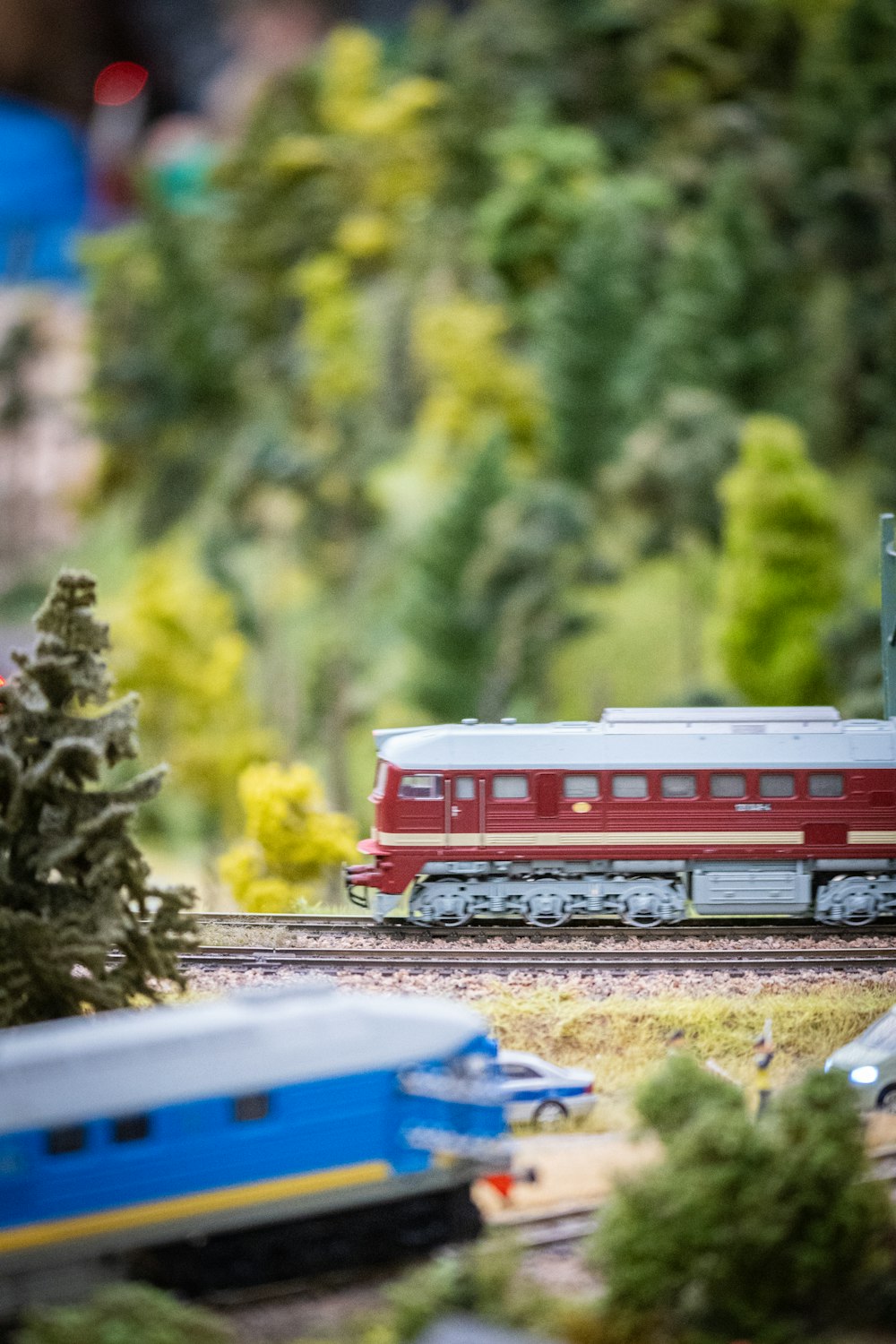 a model train set with a red and white train on the tracks