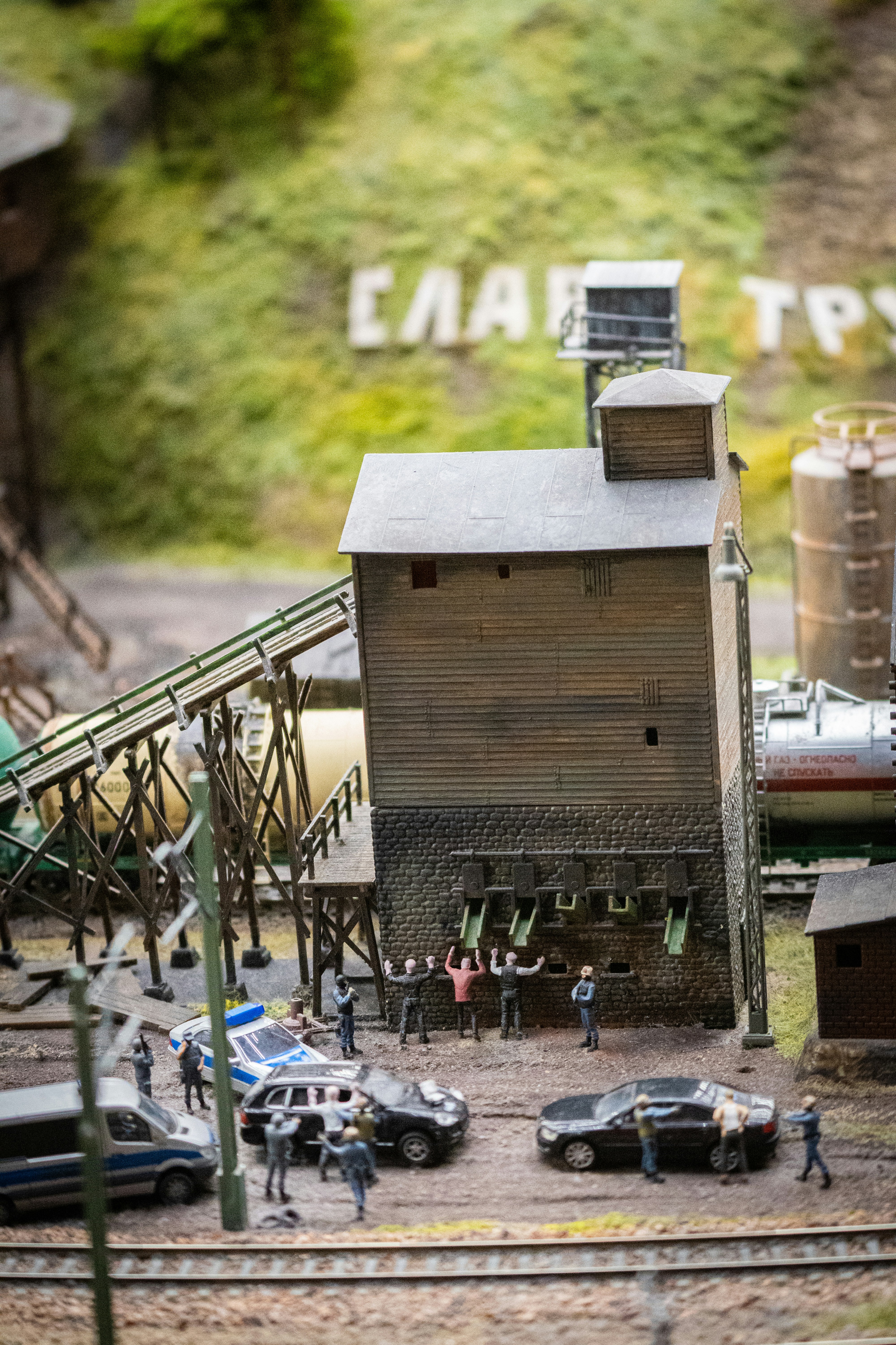 A model of a train station with cars and people