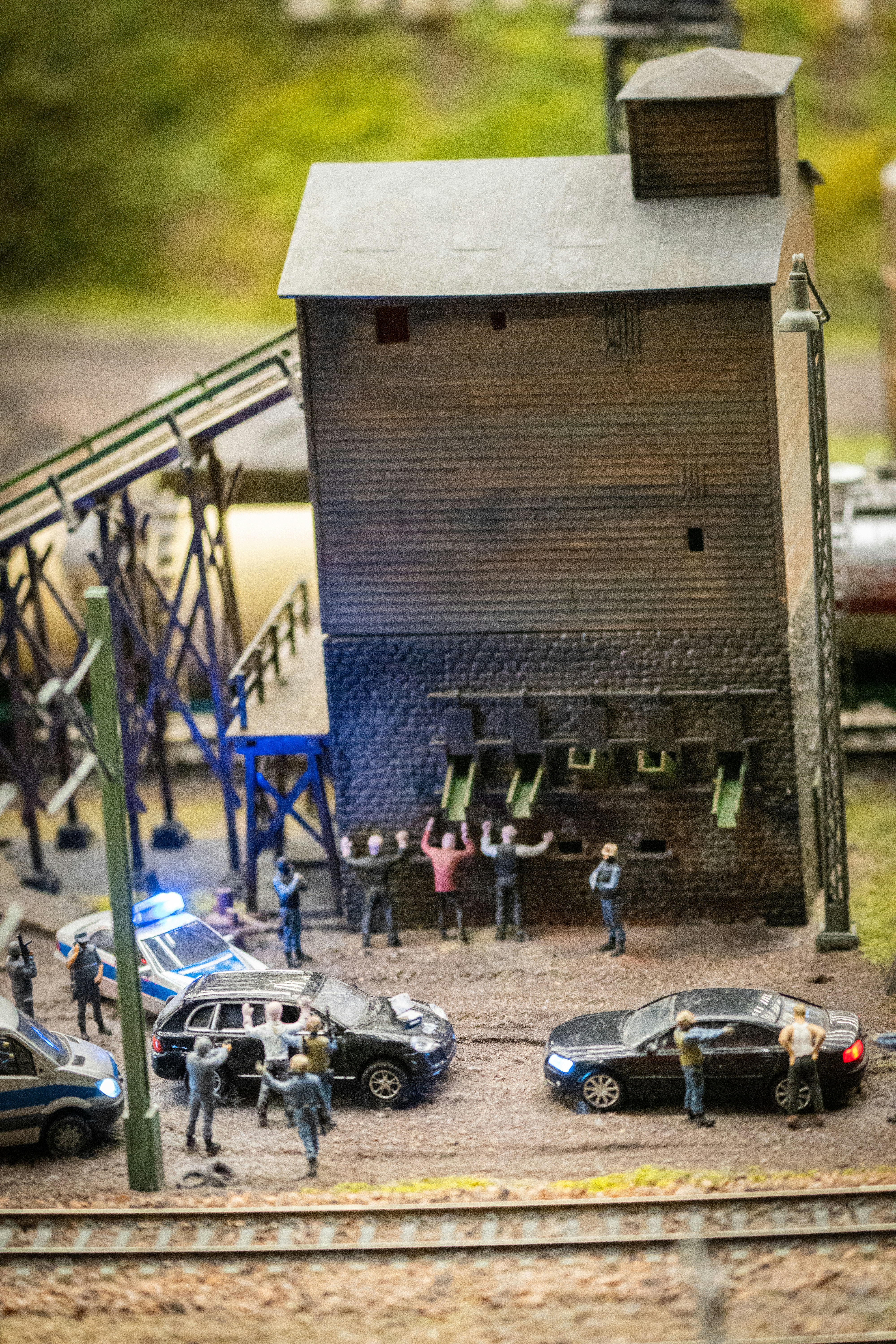 A model of a train station with cars and people