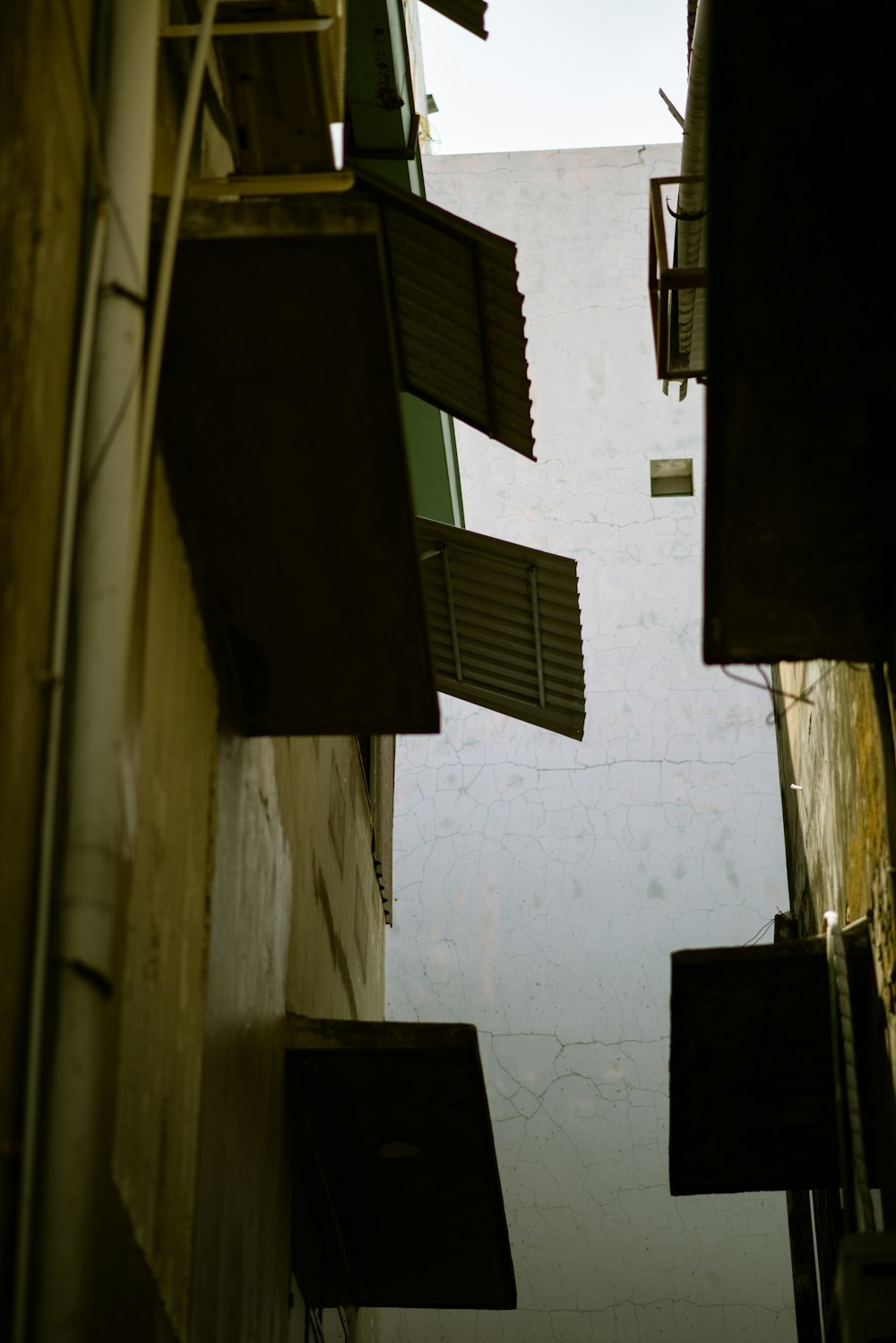 a narrow alley way with a clock on the side