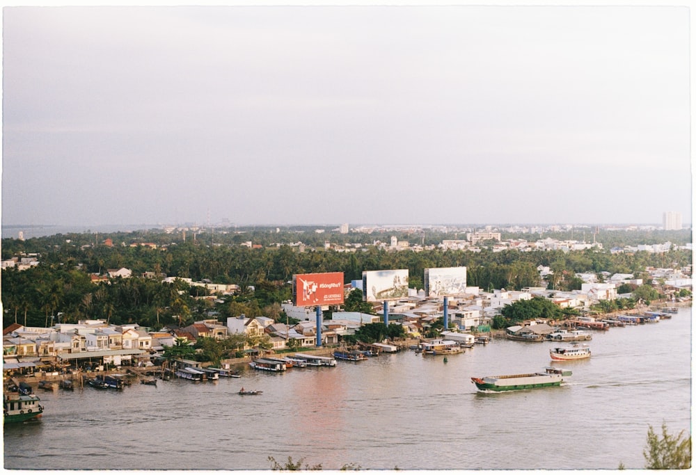 a river filled with lots of boats next to a city