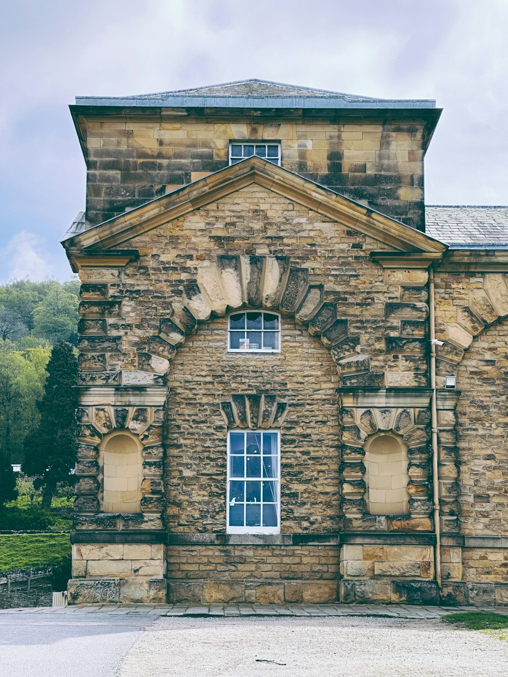 an old stone building with a clock on the front of it