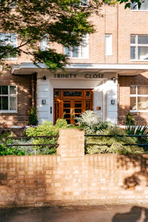 A welcoming office entrance of Trinity Associates with architectural sketches displayed on the wall.