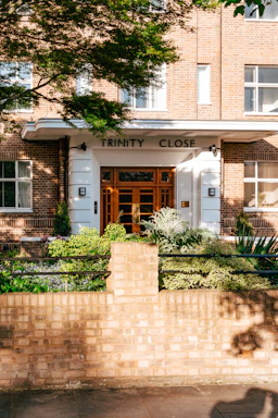 A welcoming office entrance of Trinity Associates with architectural sketches displayed on the wall.