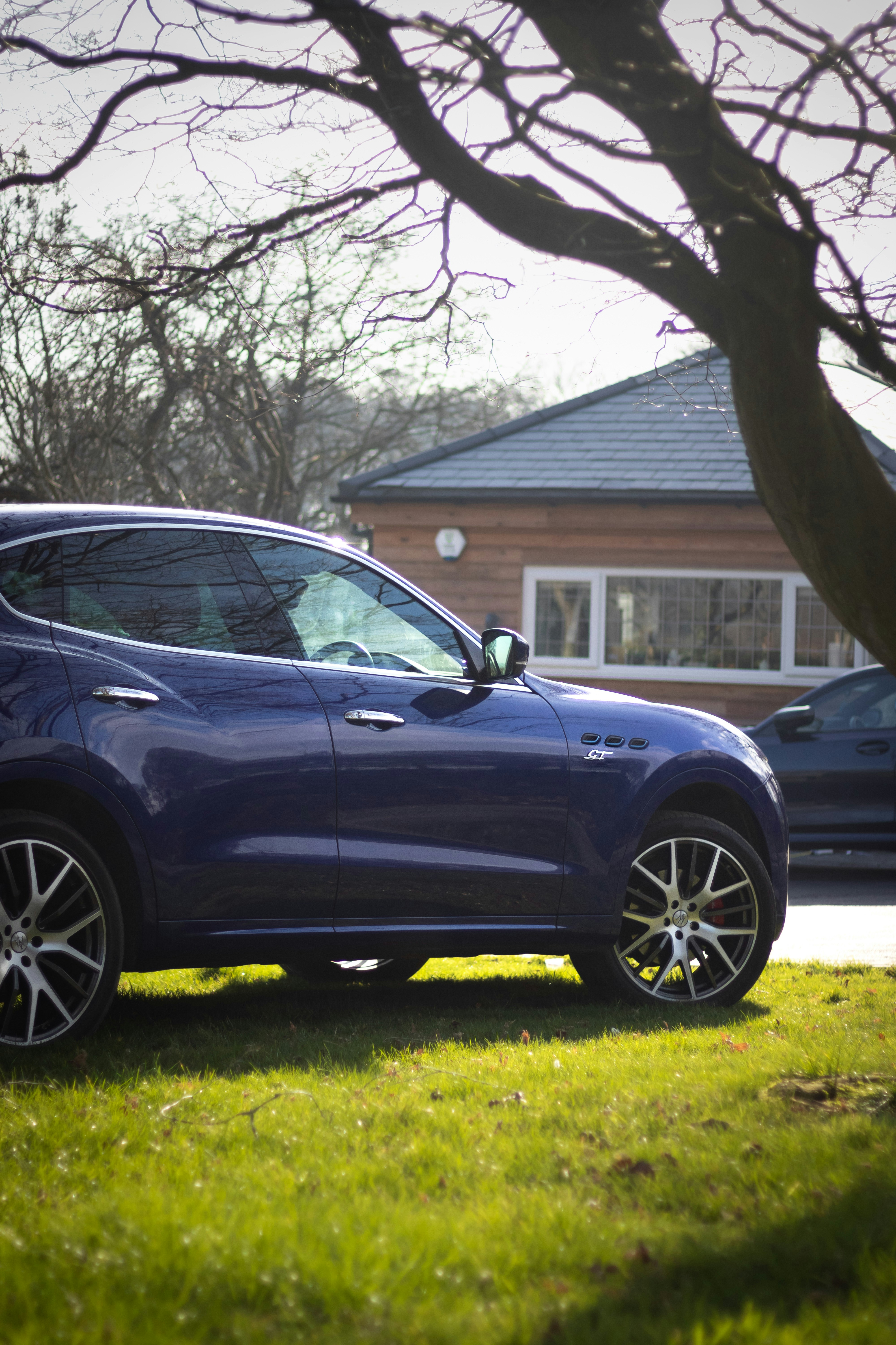 a blue car parked in front of a house