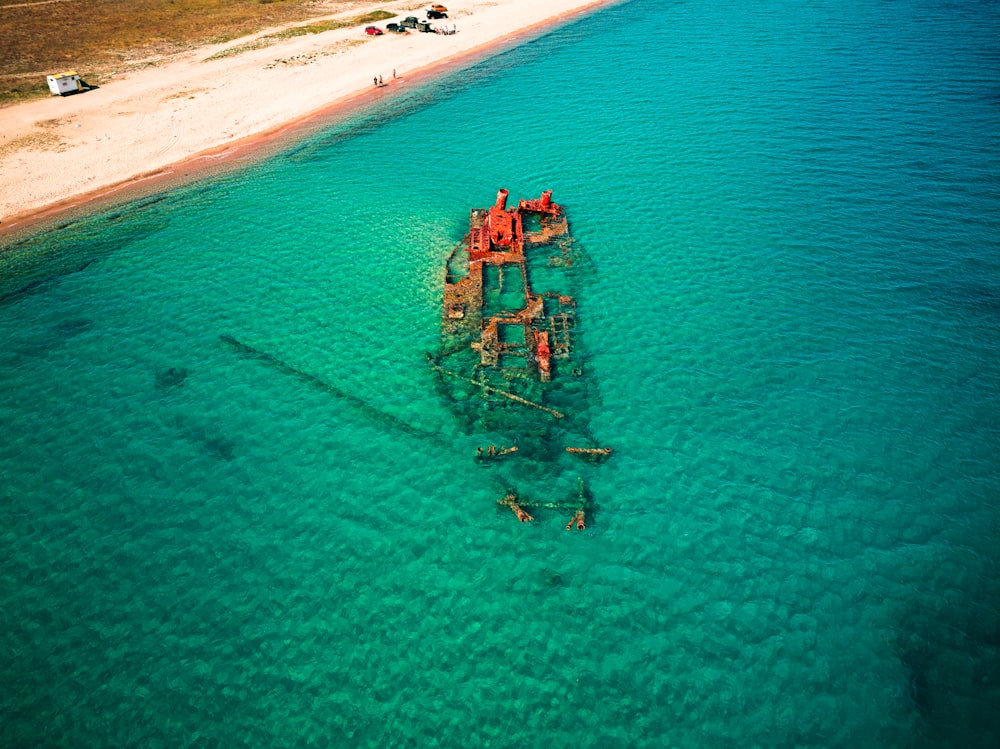 a boat sitting in the middle of a body of water