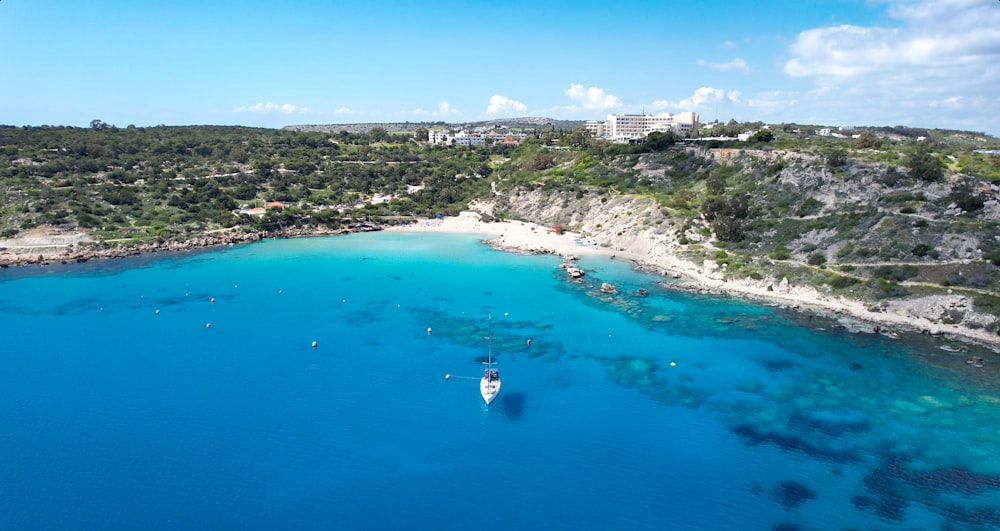 an aerial view of a beach with boats in the water