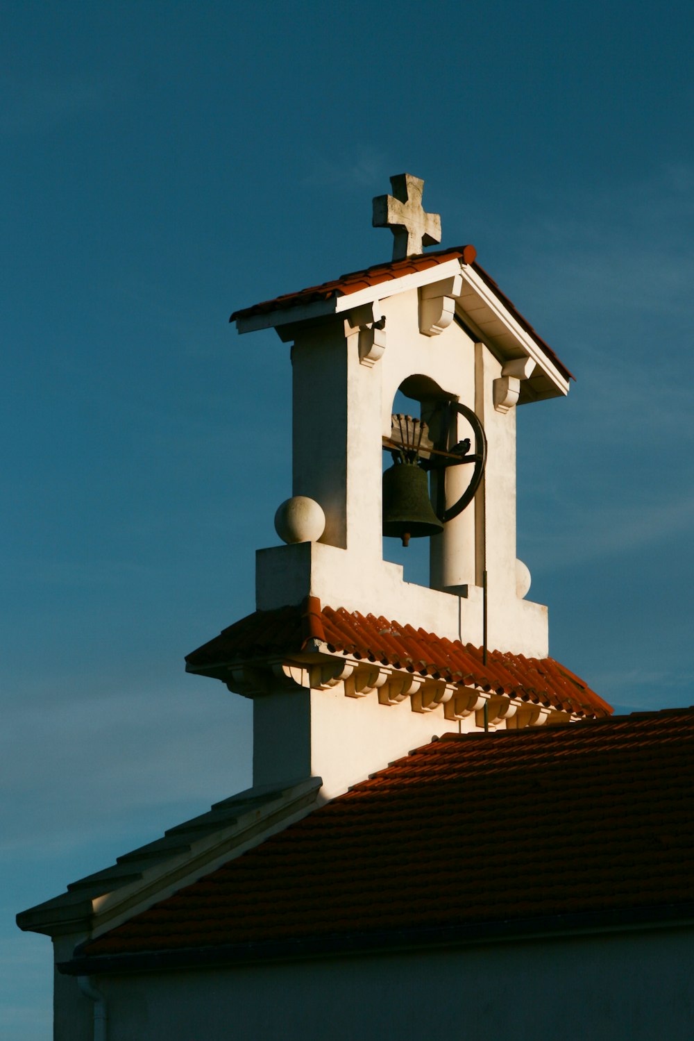 a bell tower with a cross on top of it