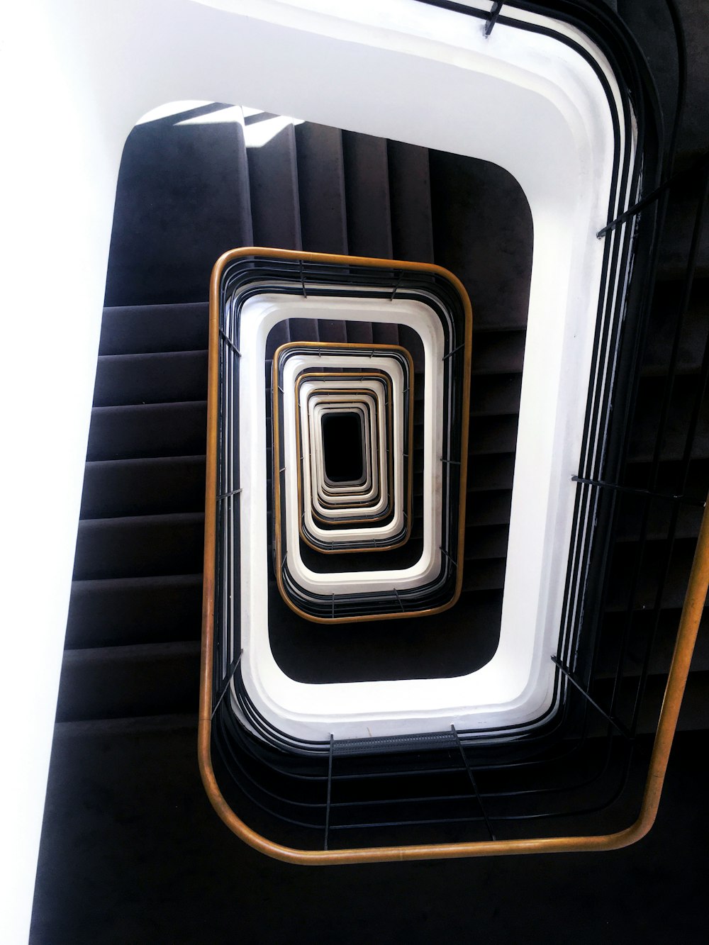 a spiral staircase with a black and white design