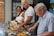 A cheerful kitchen scene with a caregiver preparing a meal alongside a client.