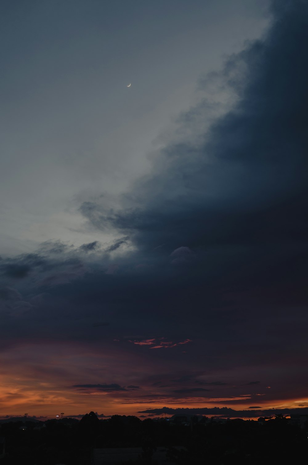 a plane flying in the sky at sunset