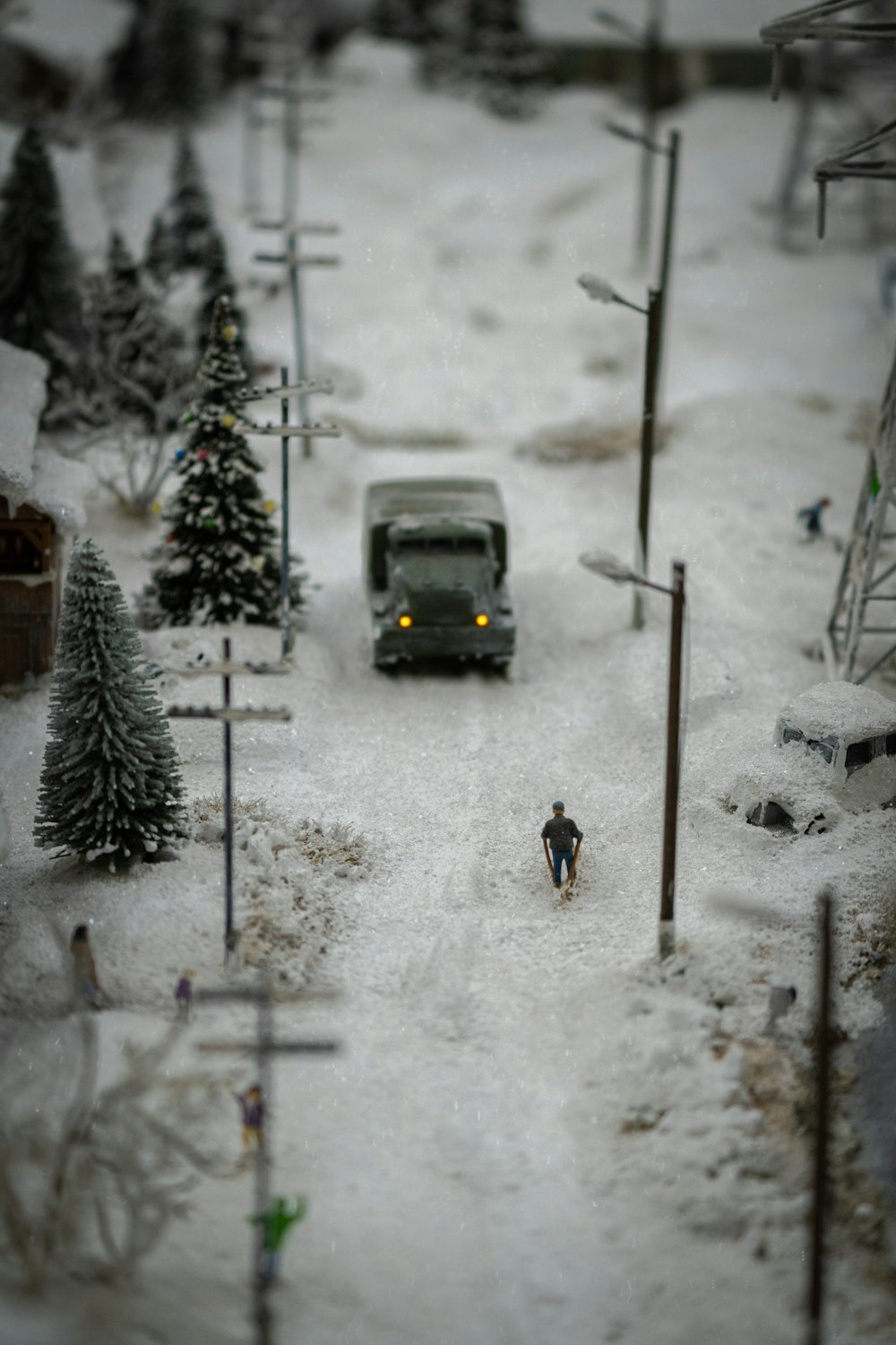 a toy car driving down a snow covered road