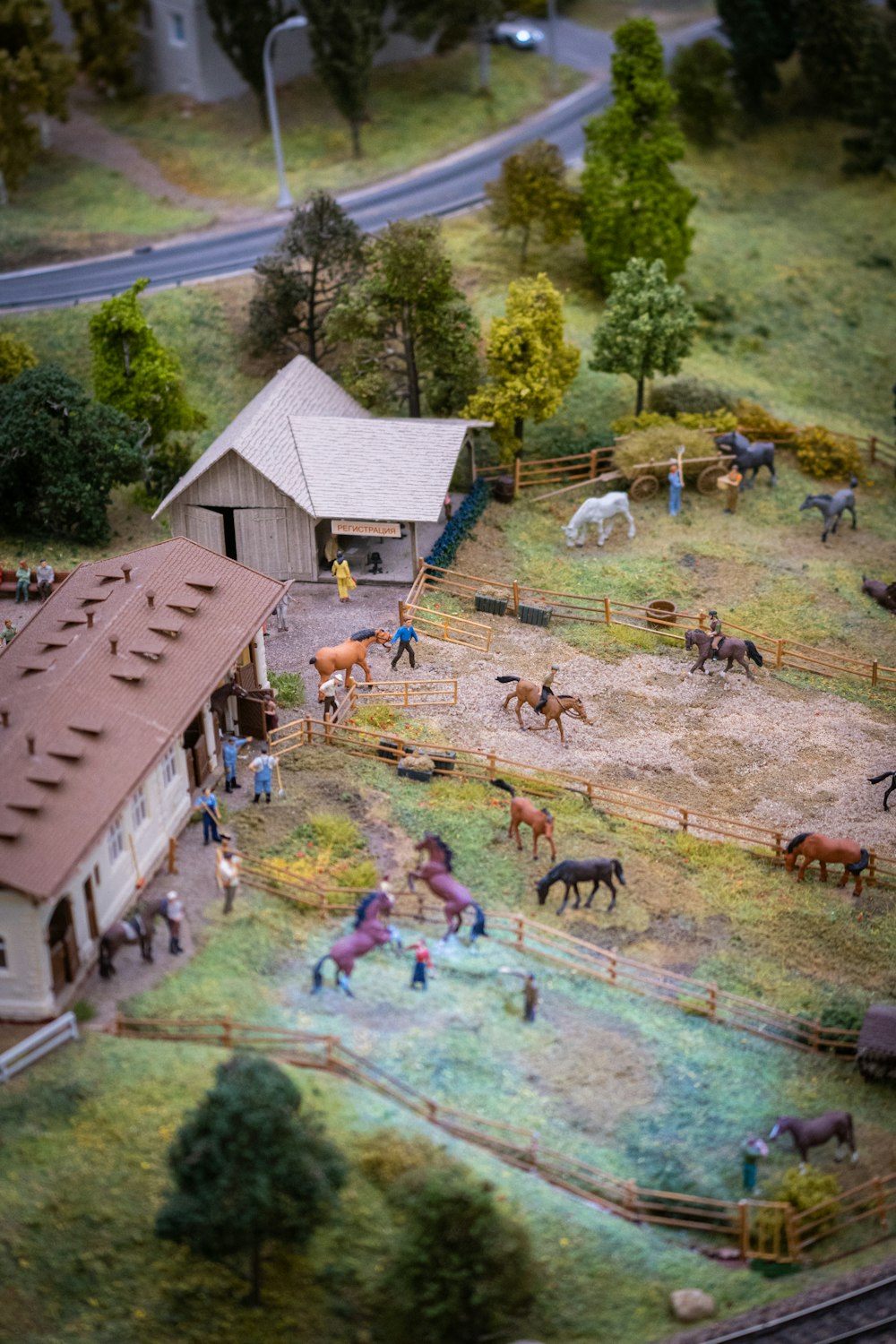 a model of a farm with horses and people