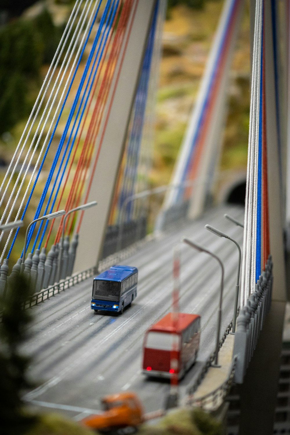 a toy model of a bridge with cars and buses on it