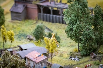 Side view of a 1/64 scale diorama depicting a countryside farm with miniature animals and crops.