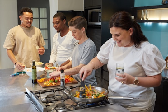 A group of food producers discussing ideas in a modern kitchen.