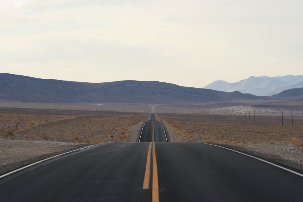 an empty road in the middle of a desert