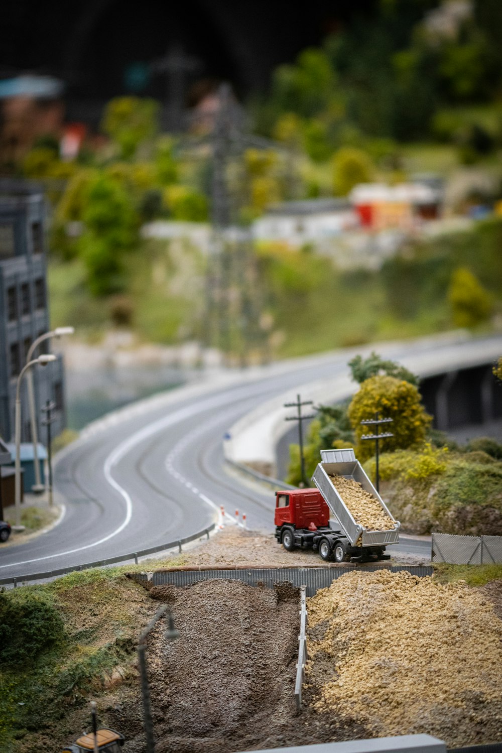 a model of a road with a red truck on it