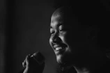 Close-up of Brazilian Suite's singer smiling while holding a microphone