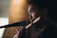 a man holding a microphone in front of a microphone