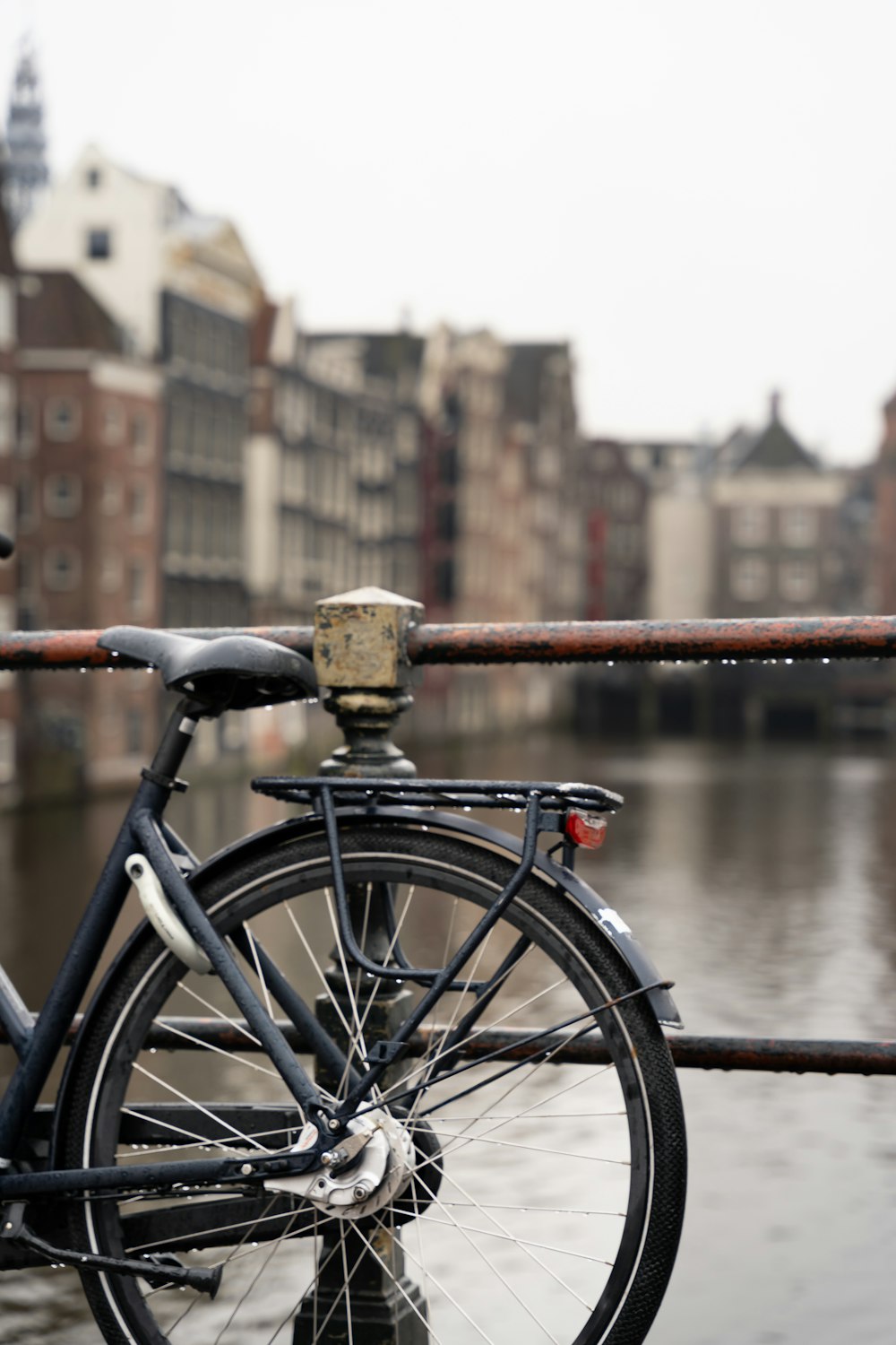 a bicycle parked on the side of a bridge