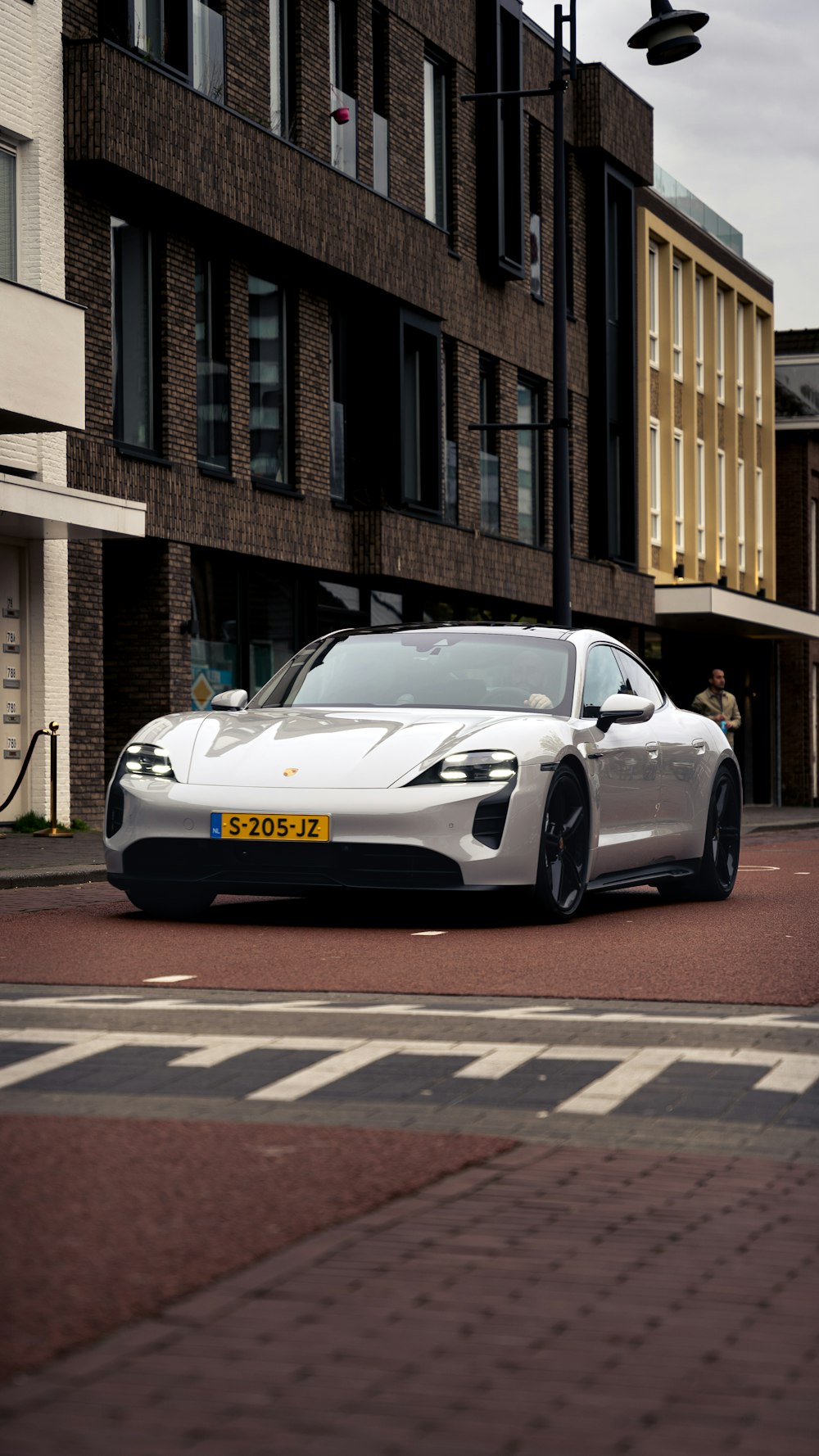 a silver sports car parked on the side of the road