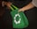 Close-up of hands exchanging a grocery bag at a friendly store counter.