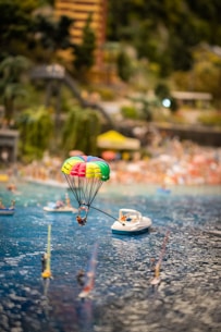 a hot air balloon floating over a body of water