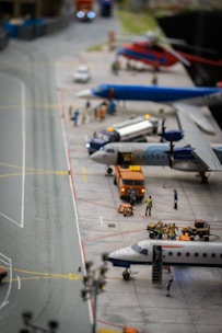 A miniature airport terminal model complete with runways, control towers, and tiny vehicles bustling around.