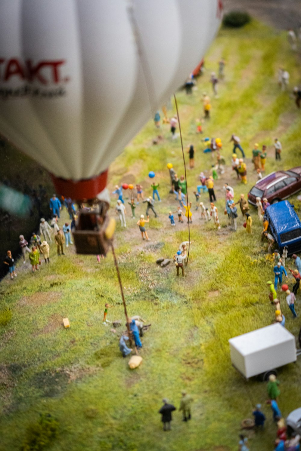 a hot air balloon flying over a group of people