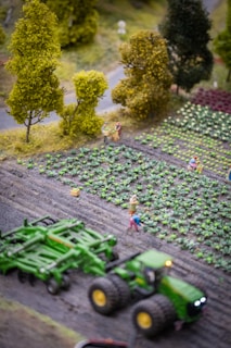 a toy farm scene with a tractor and people