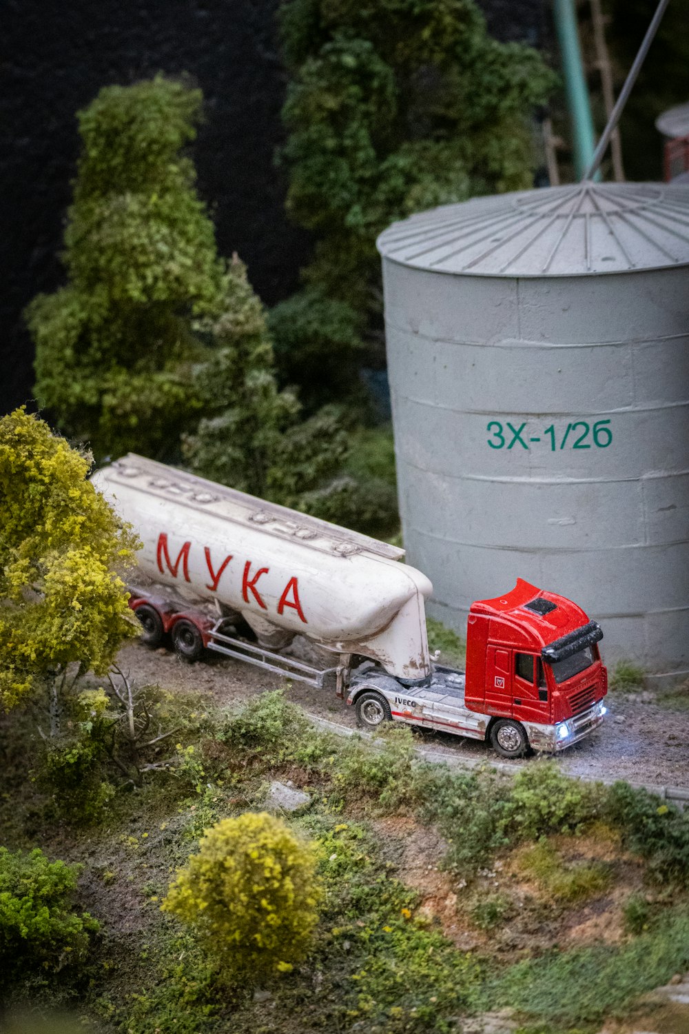 a model of a red truck and a white trailer