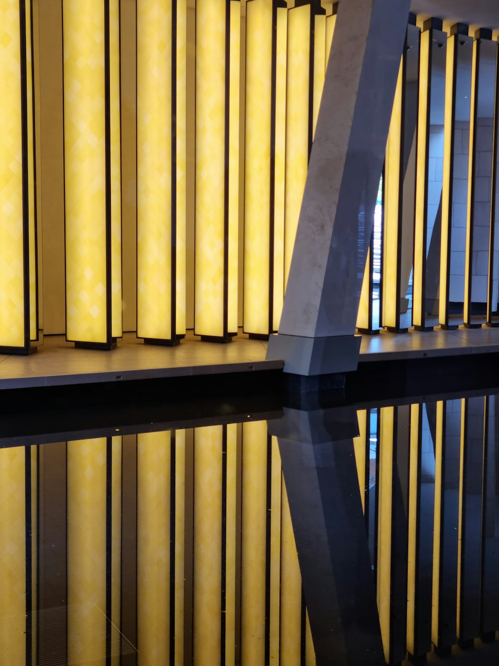 a reflection of a building in a pool of water