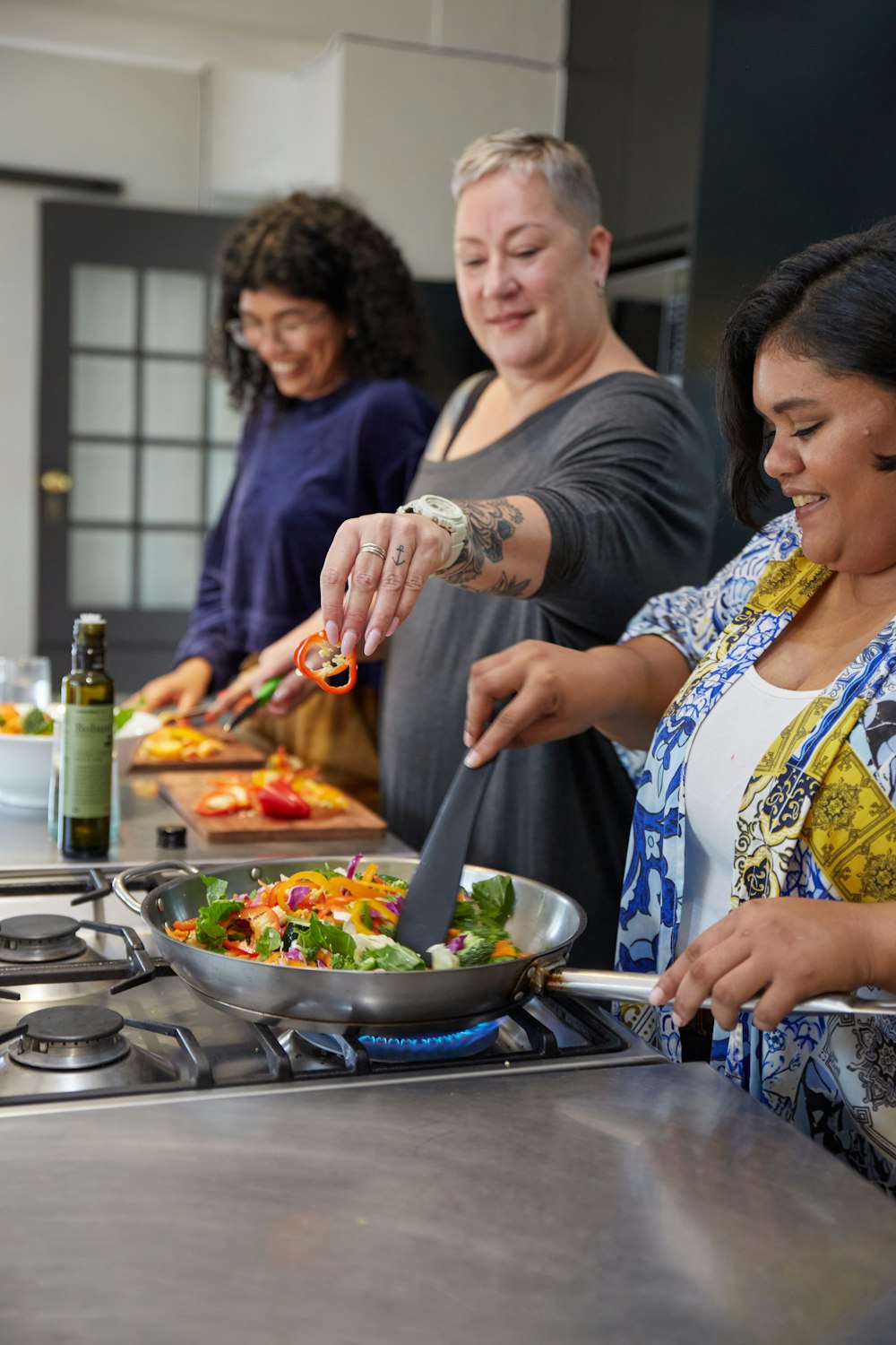 a group of people preparing food in a kitchen