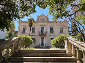 The exterior of a grand Bonanza Homes super home with manicured landscaping and elegant architecture
