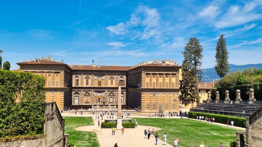 a group of people standing in front of a large building