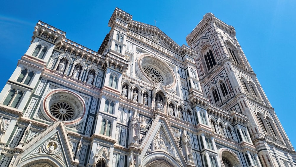 a tall cathedral with a clock on the front of it